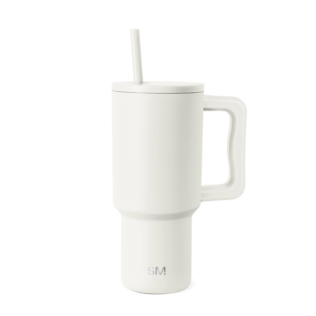 Cream-white insulated tumbler with handle, fitted lid, and straw on white background. Simple Modern logo visible on lower front. Matte finish stainless steel drinkware with modern tapered design. Cream-white insulated tumbler with handle, fitted lid, and straw on white background. Simple Modern logo visible on lower front. Matte finish stainless steel drinkware with modern tapered design.