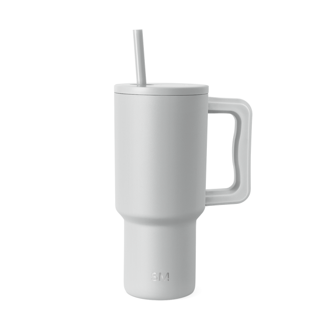 White insulated tumbler with matching lid, handle, and straw on white background White insulated tumbler with matching lid, handle, and straw on white background