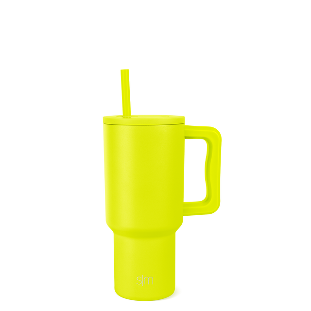 Bright neon yellow tumbler with handle on white background, cylindrical shape with tapered base widening toward top Bright neon yellow tumbler with handle on white background, cylindrical shape with tapered base widening toward top