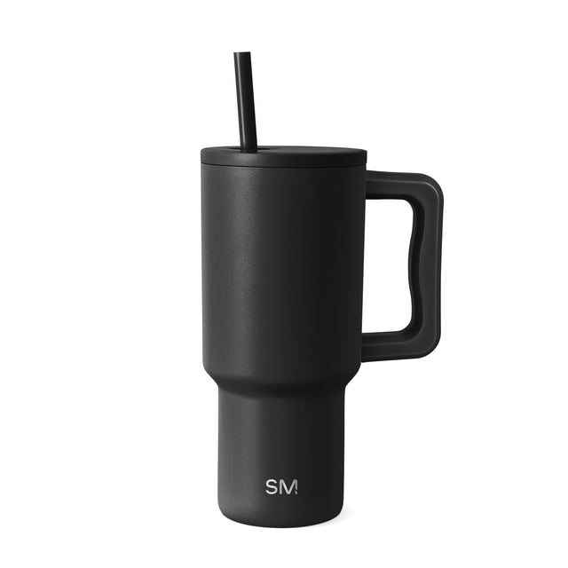 Matte black 30-ounce insulated tumbler with handle and black straw by Simple Modern, shown against white background Matte black 30-ounce insulated tumbler with handle and black straw by Simple Modern, shown against white background