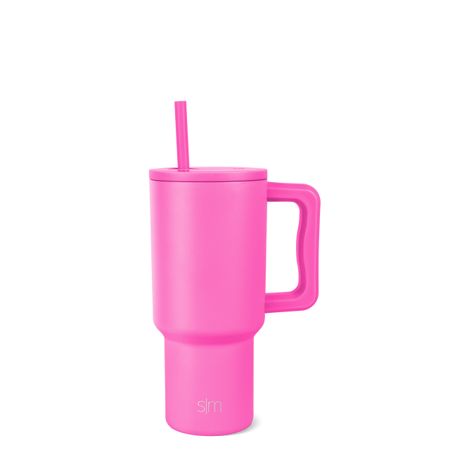 Hot pink tumbler with lid and straw on white background Hot pink tumbler with lid and straw on white background