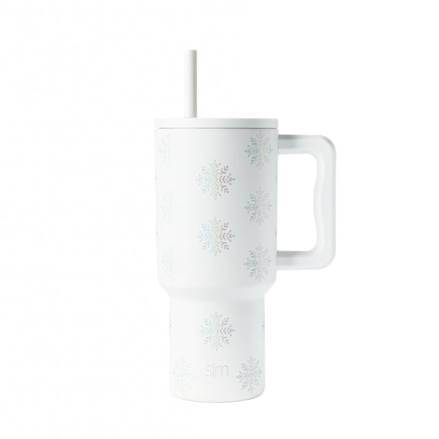 White insulated tumbler with gray-blue snowflake pattern, white straw and handle White insulated tumbler with gray-blue snowflake pattern, white straw and handle
