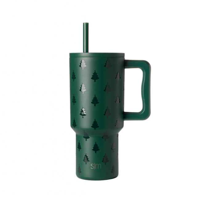 Forest green tumbler with white evergreen tree silhouettes in repeating pattern against white background Forest green tumbler with white evergreen tree silhouettes in repeating pattern against white background