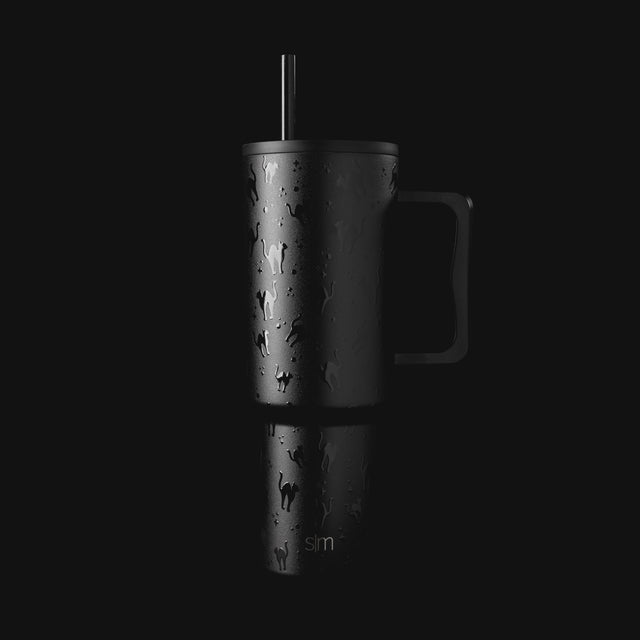 Black and charcoal gray insulated tumbler with metallic silver accents on the straw and lid rim Black and charcoal gray insulated tumbler with metallic silver accents on the straw and lid rim