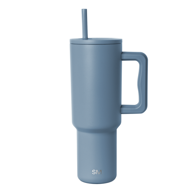 Slate blue insulated tumbler with tapered cylindrical design and minimalist contemporary aesthetic Slate blue insulated tumbler with tapered cylindrical design and minimalist contemporary aesthetic