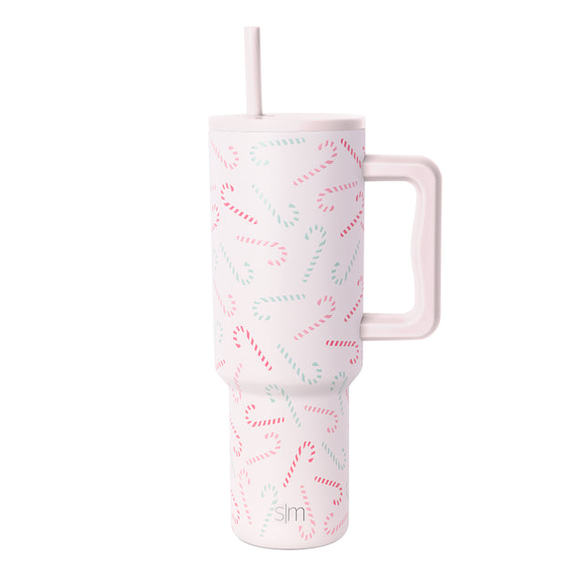 White insulated tumbler with handle featuring an all-over repeating candy cane pattern in pink and seafoam green stripes on plain white background. White insulated tumbler with handle featuring an all-over repeating candy cane pattern in pink and seafoam green stripes on plain white background.