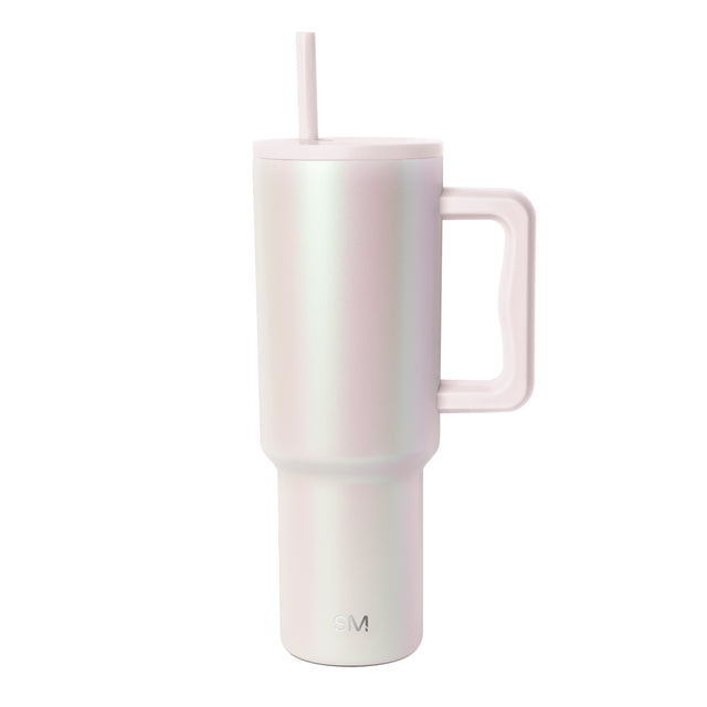Pale blush pink and cream iridescent tumbler with pearlescent shimmer and subtle color transitions across cylindrical body Pale blush pink and cream iridescent tumbler with pearlescent shimmer and subtle color transitions across cylindrical body