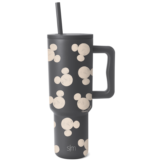 Charcoal gray insulated tumbler with handle featuring repeating cream-colored circles pattern, displayed against white background. Charcoal gray insulated tumbler with handle featuring repeating cream-colored circles pattern, displayed against white background.