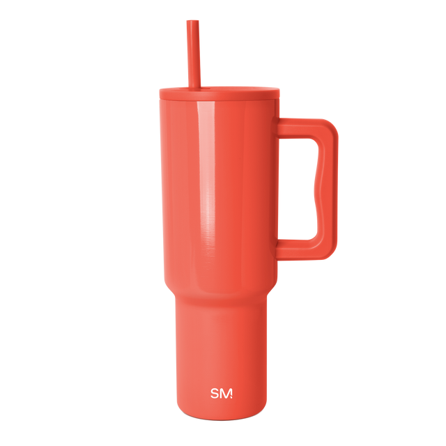 Coral-red tumbler with white background Coral-red tumbler with white background