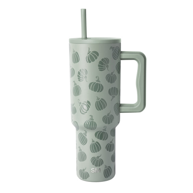 Pale sage green insulated tumbler with handle featuring an all-over pumpkin pattern in darker green, shown on white background. Pale sage green insulated tumbler with handle featuring an all-over pumpkin pattern in darker green, shown on white background.