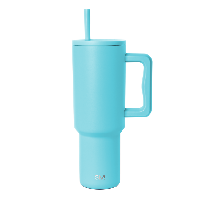 Tall insulated tumbler in bright aqua blue with tapered cylindrical design, photographed against white background Tall insulated tumbler in bright aqua blue with tapered cylindrical design, photographed against white background
