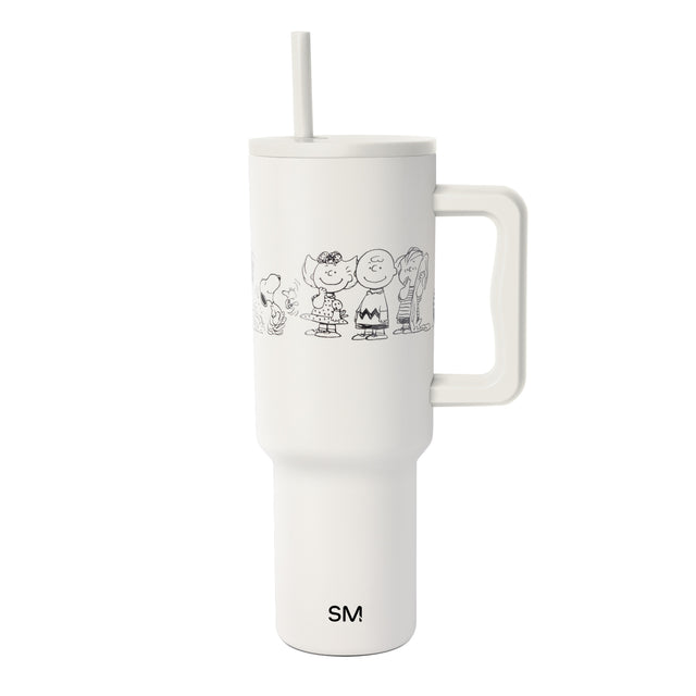 Cream-colored drinkware with black line art graphic design Cream-colored drinkware with black line art graphic design