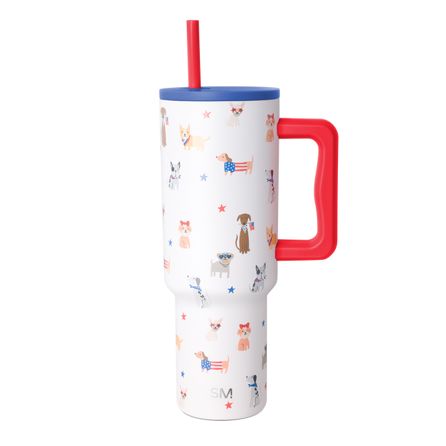 White insulated tumbler with handle featuring patriotic dog-themed pattern with various dog breeds wearing patriotic accessories on white background White insulated tumbler with handle featuring patriotic dog-themed pattern with various dog breeds wearing patriotic accessories on white background