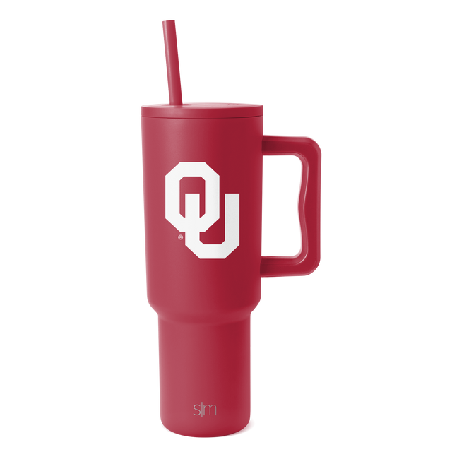 Crimson red insulated tumbler with tapered cylindrical design on white background Crimson red insulated tumbler with tapered cylindrical design on white background