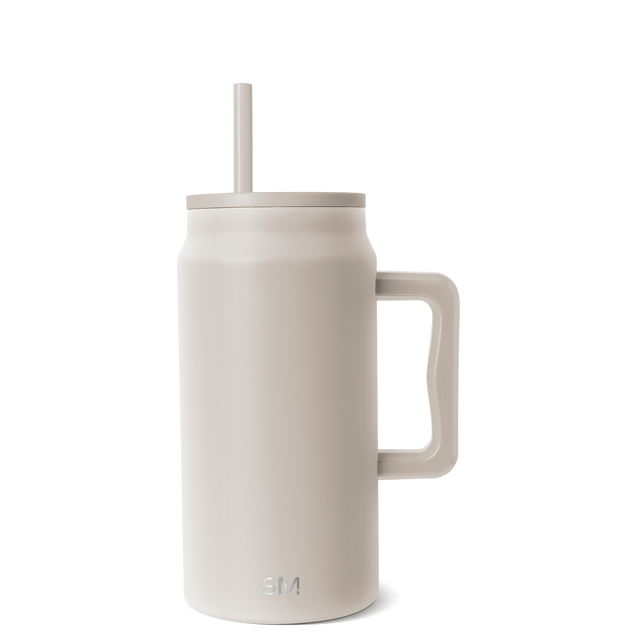 Cream-colored insulated tumbler with beige lid, handle, and matching straw Cream-colored insulated tumbler with beige lid, handle, and matching straw