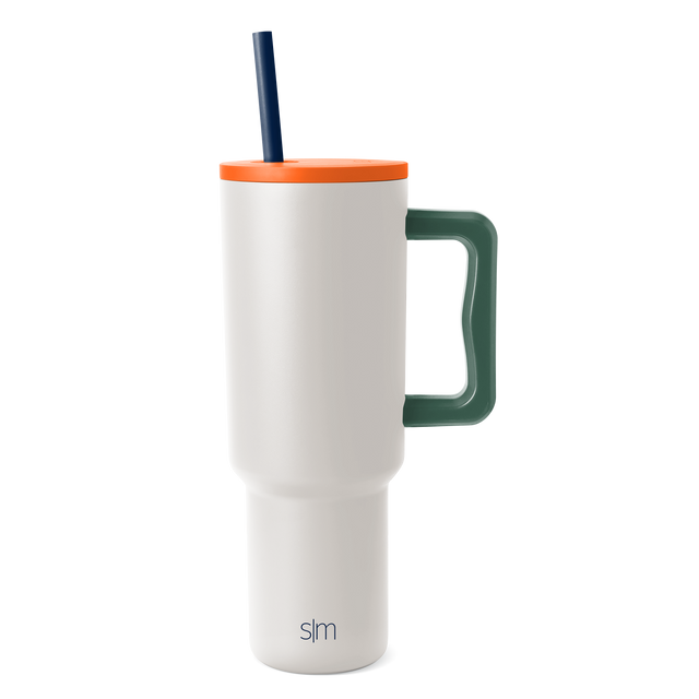 White tumbler with bright orange lid, forest green handle, and dark navy blue straw White tumbler with bright orange lid, forest green handle, and dark navy blue straw