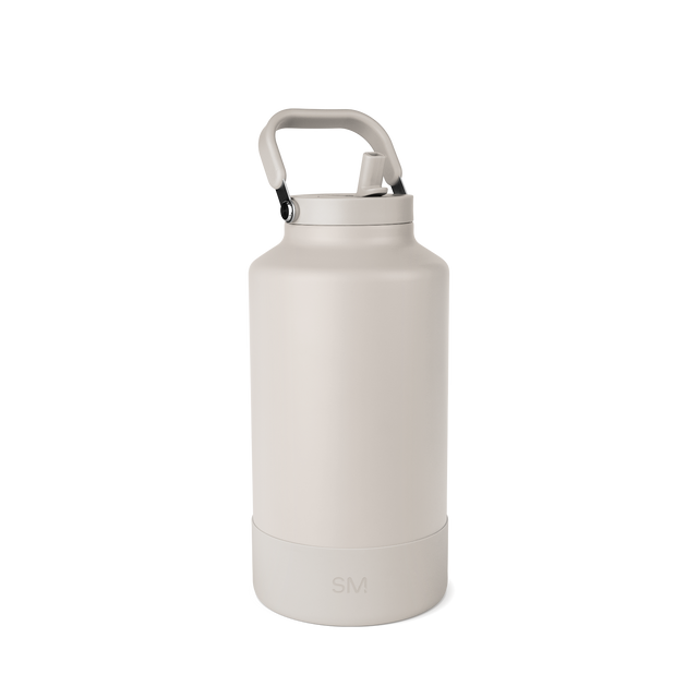 Off-white cream-colored product with gray metal hardware accents on cap and handle. Off-white cream-colored product with gray metal hardware accents on cap and handle.