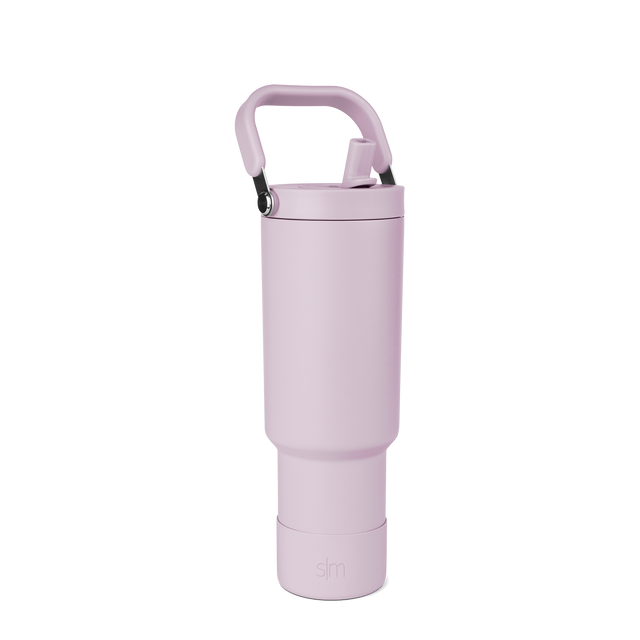 Lavender-pink spray bottle with handle and trigger, displayed against white background Lavender-pink spray bottle with handle and trigger, displayed against white background