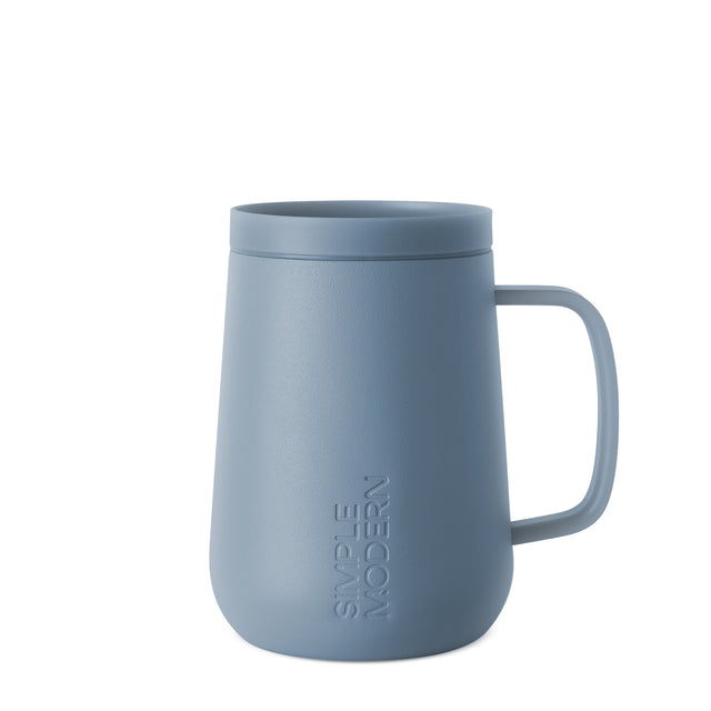 Dusty slate blue ceramic mug with muted powder finish, displayed against a neutral background Dusty slate blue ceramic mug with muted powder finish, displayed against a neutral background