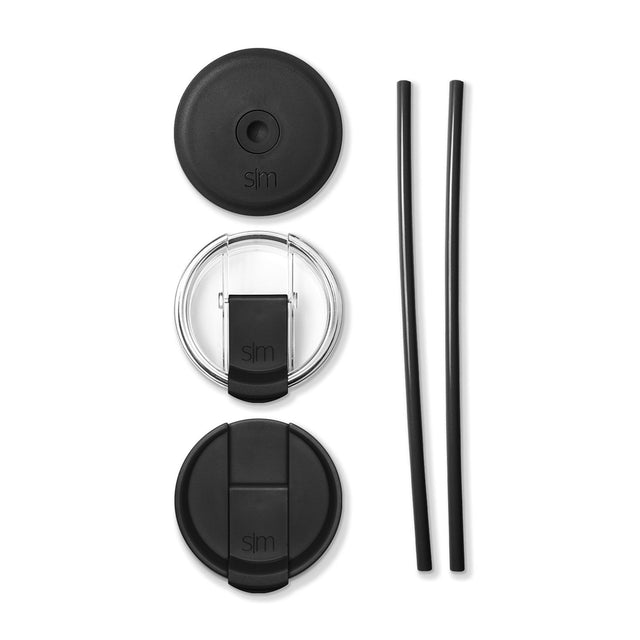 Three black circular lids and two black straws on white background Three black circular lids and two black straws on white background