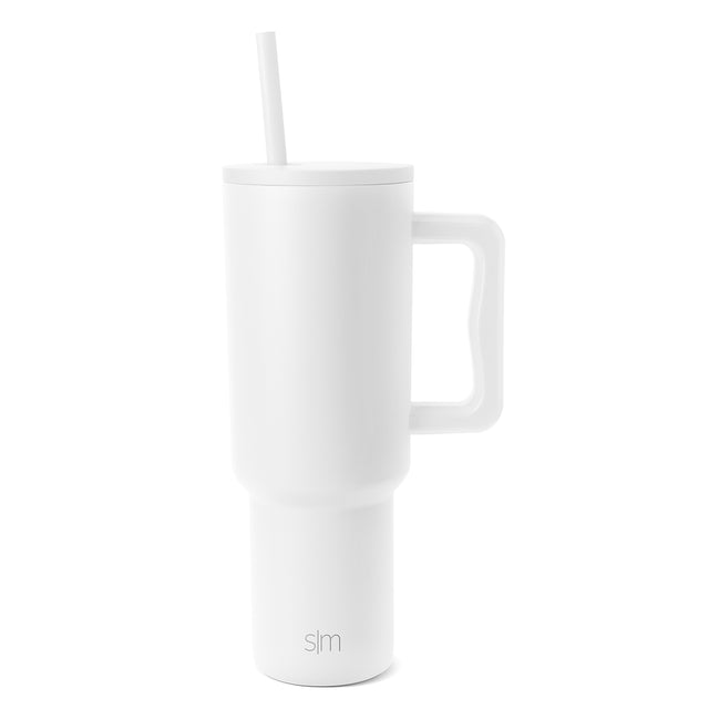 White Trek Tumbler with lid and straw, featuring ergonomic handle and SM logo, photographed against neutral background.