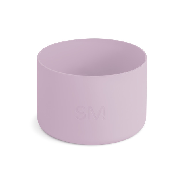 Mauve and lavender pink cylindrical boot or container on off-white background