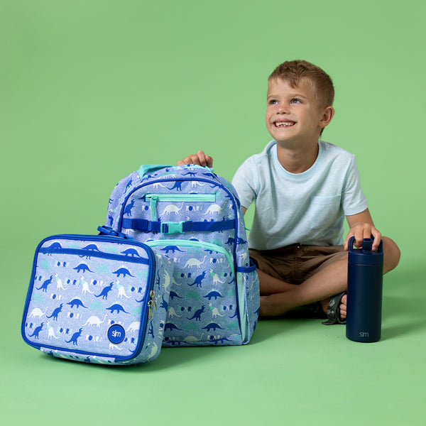 Sage green studio background with lavender-blue dinosaur-patterned products featuring navy blue dinosaur silhouettes and mint accents, displayed as a checklist banner.