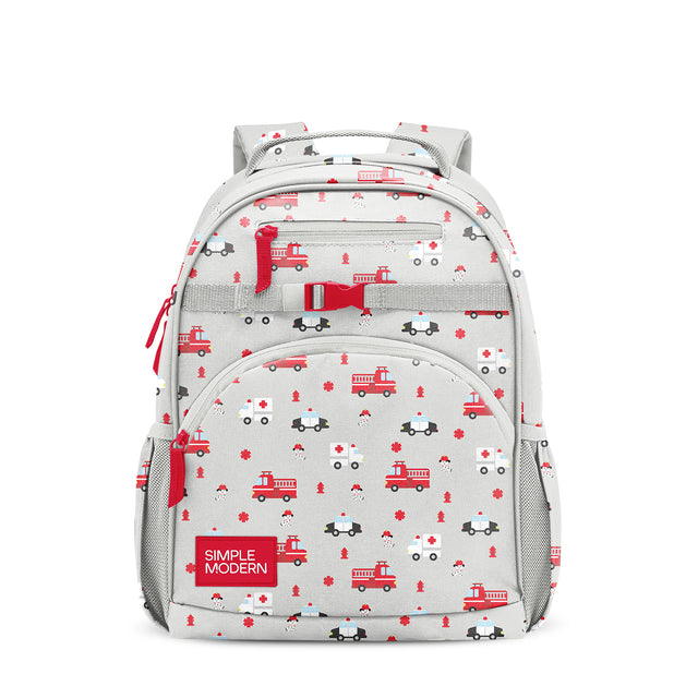 Light gray children's backpack with all-over pattern of red emergency vehicles including fire trucks, police cars, and ambulances, plus fire hydrants and snowflakes. Features padded straps, mesh pocket, and red zipper.
