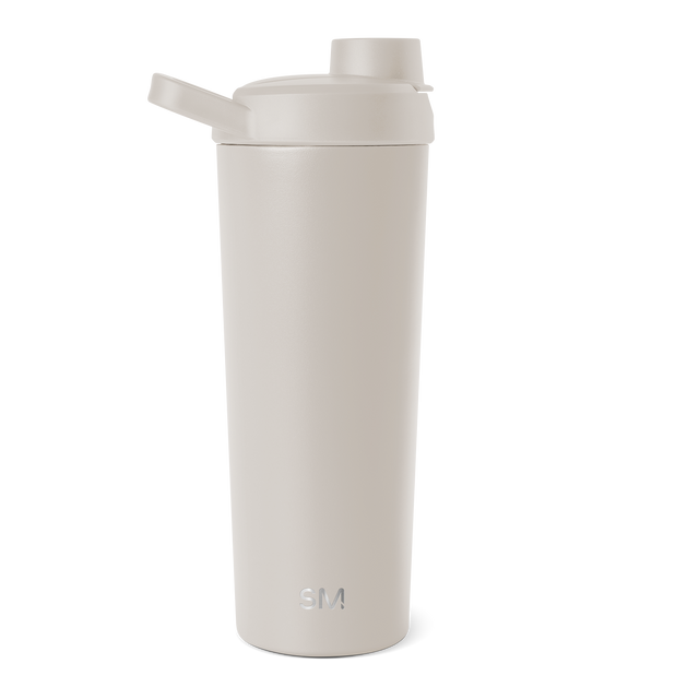 Cylindrical cream-colored vessel with soft neutral beige tones and minimalist design against a plain background.