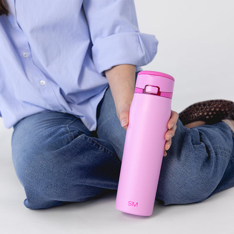 Simple Modern water bottle in vibrant hot pink color against a soft pink and light lavender background