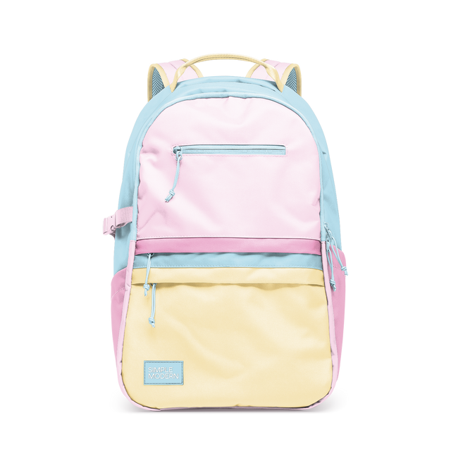 Soft pastel color-block backpack with light blue frame, pale pink upper compartment, and soft yellow lower compartment.