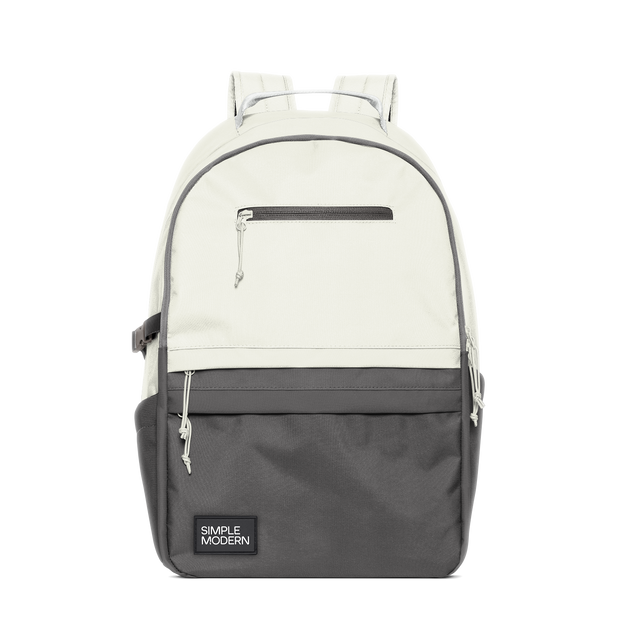 Two-tone backpack with cream upper half and dark charcoal gray lower half, separated by gray accent trim