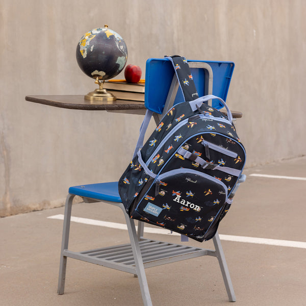 Modern blue armchair with personalization options displayed on mobile phone screen, showing gold and orange accent details against concrete background