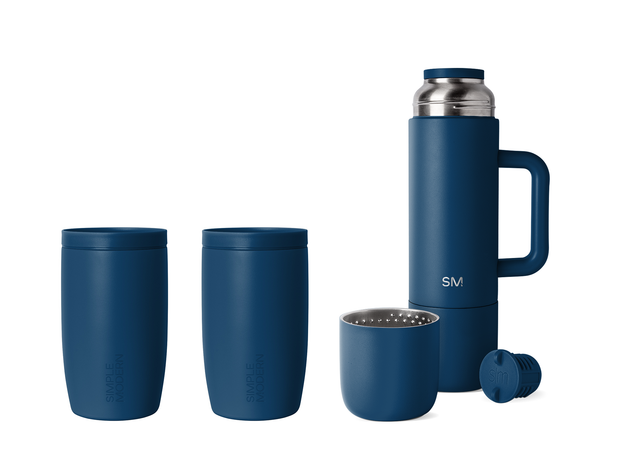 Five navy blue kitchen products with stainless steel accents arranged together, including cookware and accessories in a coordinated bundle set