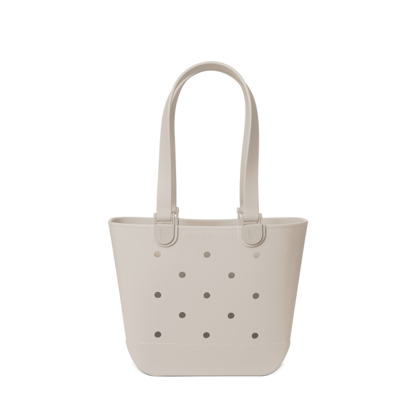 Soft beige canvas tote bag displayed against a light gray-white background