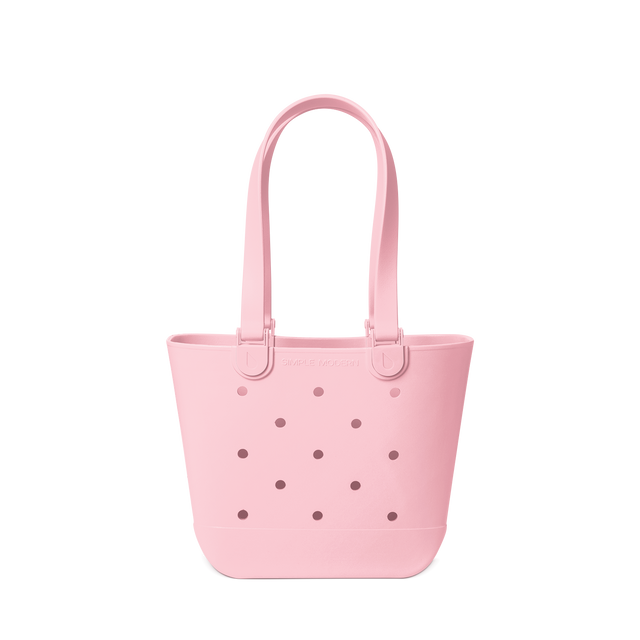 Soft pink tote bag against a white background