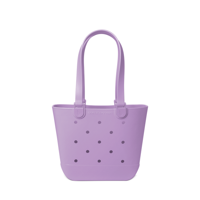 Soft lavender purple tote bag with decorative perforations in darker purple and gray tones on the front panel.