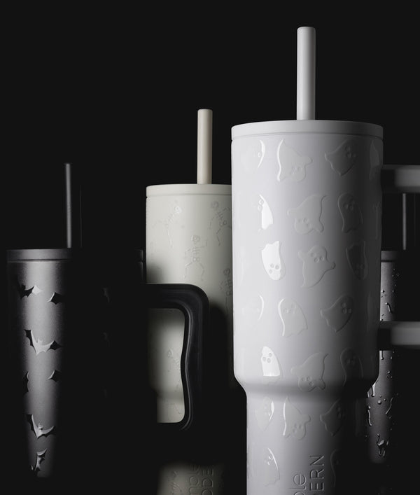 Group of white drinkware with gray shadows on black background, harvest-themed product collection shot