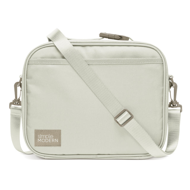 Soft sage green crossbody bag with compact rectangular silhouette and rounded corners on white background