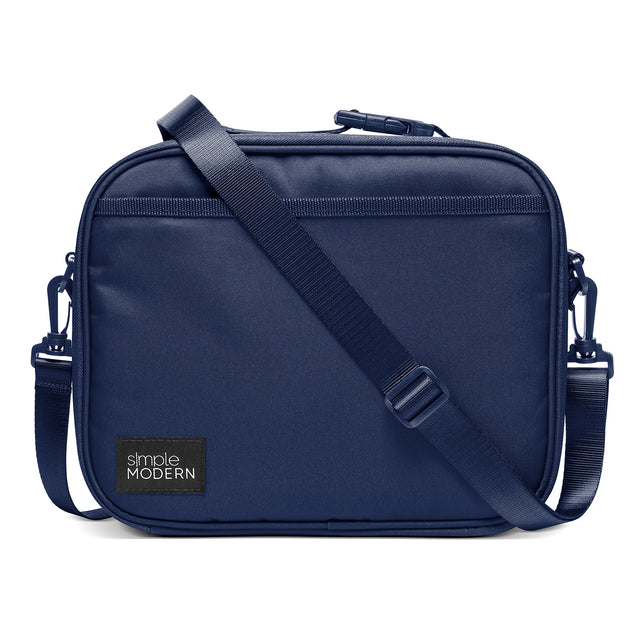 Navy blue structured crossbody bag with rounded corners on white background