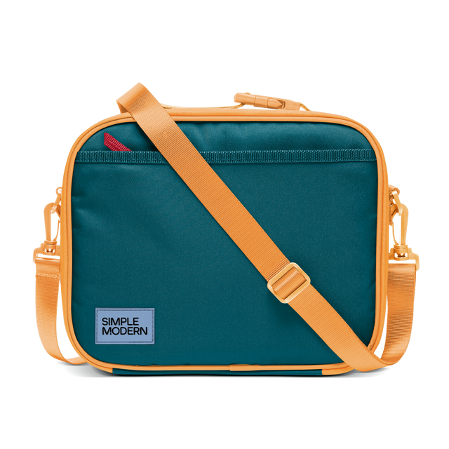 Deep teal canvas bag with apricot orange trim, piping, handles, and shoulder strap