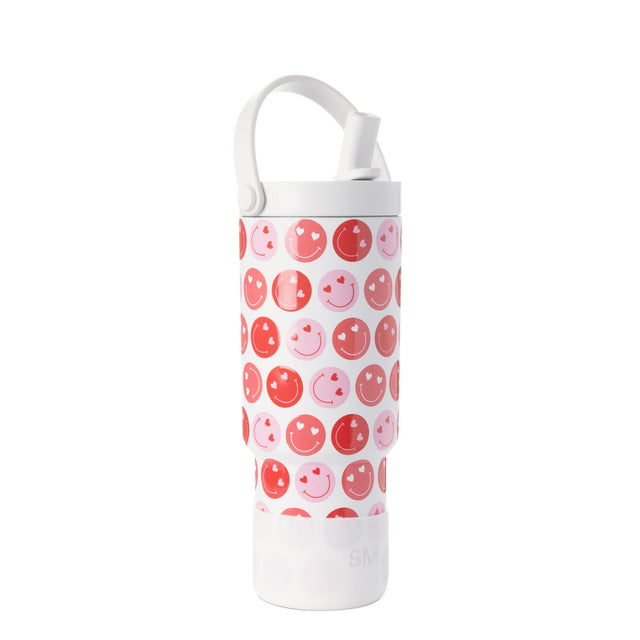White cylindrical tumbler with repeating coral, bright red, and soft pink smiley face pattern, white cap and lid ring visible.