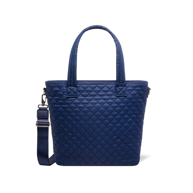 Navy blue tote bag with carabiner clip and metal hardware accents on shoulder strap