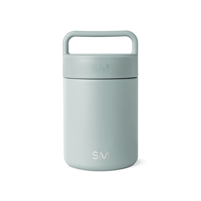 Sage green glass jar with white background, featuring a minimalist design and neutral aesthetic