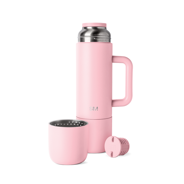 Pale pink mug with stainless steel handle and rim, part of a drinkware collection in soft rose tones with silver metal accents