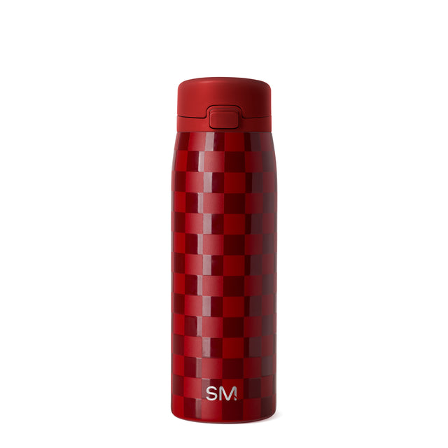 Deep red and burgundy bottle with geometric checkered pattern in alternating red tones and solid matte red cap