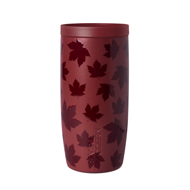 Burgundy tumbler with lid featuring scattered maple leaf pattern on white background