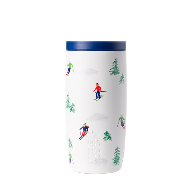 White cylindrical tumbler with navy blue lid featuring forest green evergreen trees design