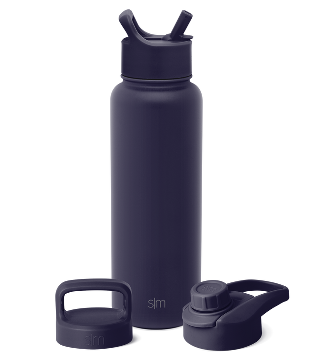 Deep navy blue insulated water bottle with matching carrying handle and two interchangeable lids shown against a neutral background.