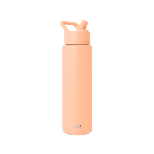 Tall cylindrical water bottle in soft peachy-coral color with ergonomic handle and modern tapered design